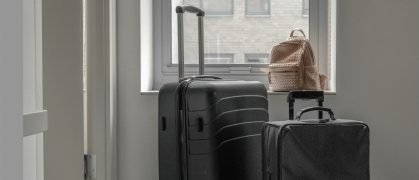 Suitcases in front of a window looking out on NYC buildings